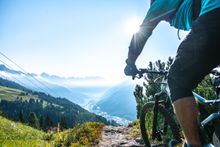 A cyclist riding a mountain bike on the Galzig Trail in St. Anton. 
