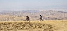 Two travellers on e-bikes ride the Jordan Trail
