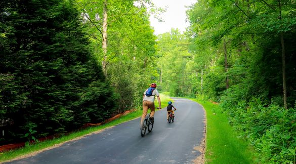 Father and son enjoy a late afternoon bike ride on the Ecusta Trail Father and son enjoy a late afternoon bike ride on the Ecusta Trail