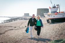 Hythe to Folkestone Walk: Art and Nostalgia - Couple walking on Firsherman's beach
