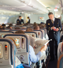 Passengers seated on a commercial airplane.