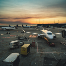 A commercial airplane parked at an airport gate.