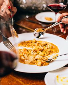 Friends share shrimp risotto at Nanas in Durham.