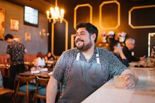 Chef Oscar Diaz sits at the bar in his restaurant, Little Bull; serving elevated, honest, comfort food inspired by first-generation American palates.