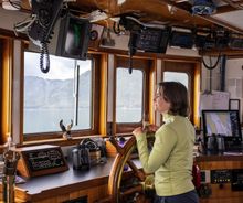 Sometimes when the water is calm and sky is clear, captains allow passengers to briefly take the wheel.