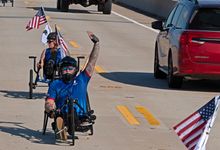 U.S. Marine Corps veteran Sergeant Matthew Hannon acknowledges drivers as he rides an adaptive bicycle on the Florida Keys Overseas Highway Friday, Jan. 9, 2026, in Marathon, Fla. Organized by the Wounded Warrior Project, the Soldier Ride brought more tha