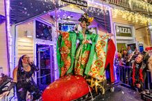 Moments after she's carefully lowered onto Duval Street during the 28th annual Red Shoe Drop, Mulan Alexander greets revelers from a giant red high-heel shoe outside the Bourbon Street Pub in Key West, Fla, on Thursday, Jan. 1, 2026. Emcee Bria Ansara (le
