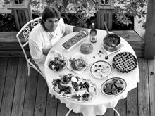 Chef Norman Van Aken, a pioneer of New World Cuisine and the only Floridian in the James Beard Foundation’s “Who’s Who of Food & Beverage in America,” poses with a table of dishes that reflect Key West’s rich culinary traditions. Van Aken helped define a 