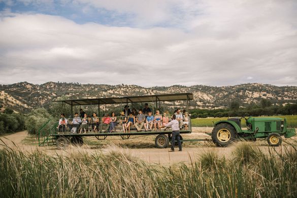 Guests join a farmer for a tractor tour of Full Belly Farm