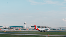 An image of a Qantas aircraft against the background of Singapore Changi Airport.