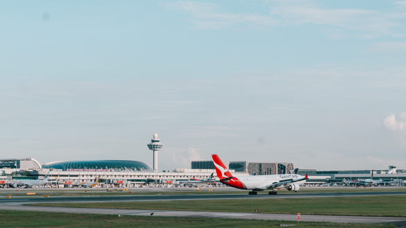 An image of a Qantas aircraft against the background of Singapore Changi Airport.