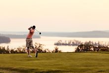 A golfer takes his shot at Belgrade Lakes Golf Club in Maine.