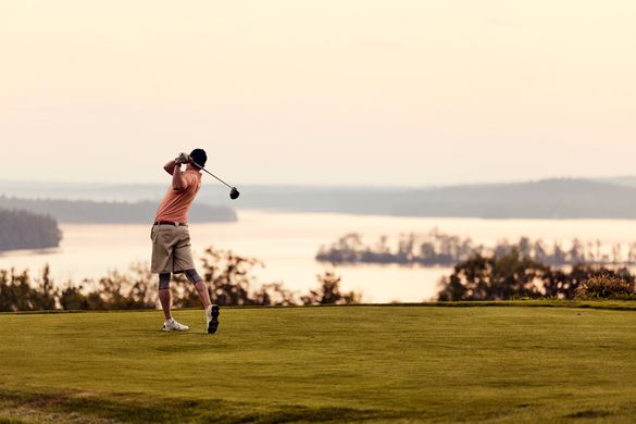 A golfer takes his shot at Belgrade Lakes Golf Club in Maine.