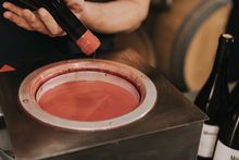 Dipping a wine bottle in wax to seal