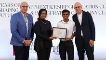 Ahmed Meesam Naeem receives his graduation certificate during the Class of 2026 ceremony