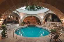 Centred around an hourglass indoor swimming pool, unwind and entertain in Boutique luxury