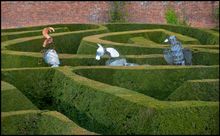 A trio of the Queen's Beasts being carried through the Marlborough Maze