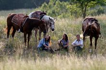Riders enjoying a break from riding with their horses at El Bronco in Hungary