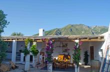 The peak of La Maroma looms above the outdoor kitchen/dining area