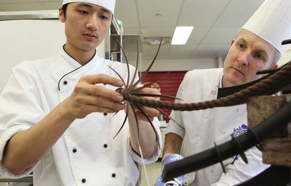 Chefs Justin Yu and Andre Sandison working on a chocolate dessert