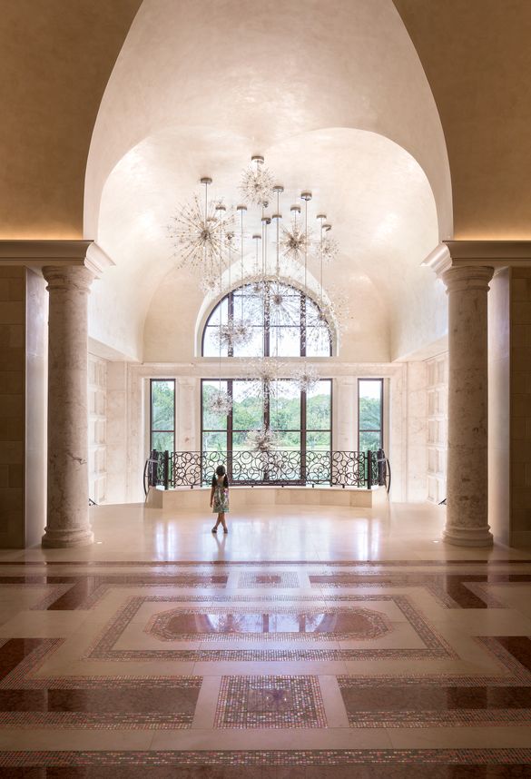  The custom firework-inspired crystal chandelier in the grand entryway evokes a sense of wonder. 