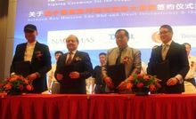 Executives from Dusit Fudu Hotels and Resorts and Rex Horizon Sdn Bhd celebrate the signing of a management agreement for Dusit 