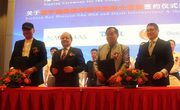 Executives from Dusit Fudu Hotels and Resorts and Rex Horizon Sdn Bhd celebrate the signing of a management agreement for Dusit 