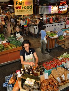 A clerk at Reading Terminal Market's Fair Food Farmstand makes sure the stands are packed with prepared foods. Also on offer at 