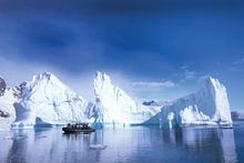 Zodiac cruising around icebergs in Antarctica