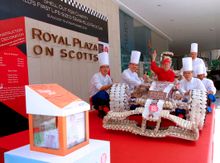 Patrick Fiat, General Manager, and team of chefs with the masterpiece, Royal Plaza on Scotts