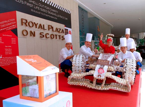 Patrick Fiat, General Manager, and team of chefs with the masterpiece, Royal Plaza on Scotts