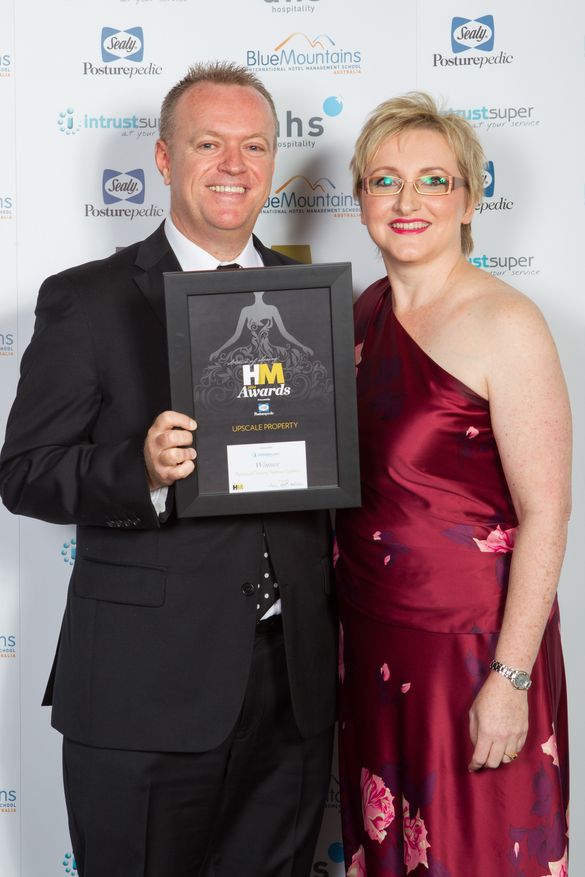 Craig Bond receives the Upscale Property Award for PARKROYAL Darling Harbour Sydney at the HM Awards 2014 from Karen Prins of In
