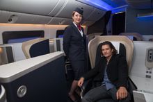 Actor, Orlando Bloom poses for a photo with British Airways staff on a British Airways Boeing 777-300 at Sydney Airport on Septe