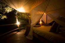 Rubondo Island Camp Tree House- Bed at night- Lanterns