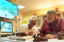 Francis Soto and Dr. Charles Beeker look at powder chamber of Columbus era cannon