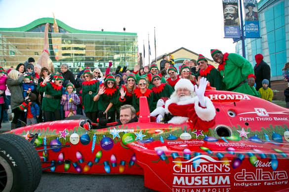 Santa zooms into the world's largest children's museum in a race car!