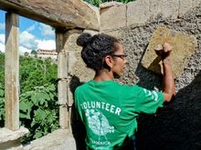 A volunteer plasters a wall in Jamaica