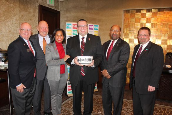 American Heart Association Director of Meetings Jason Ware (center) receives the Liberty Bowl, Philadelphia’s highest honor, fro