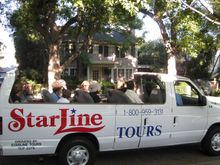 Passengers aboard an open-air Starline Tour bus pass by the original �Halloween� movie house in Beverly Hills, California.  Scar