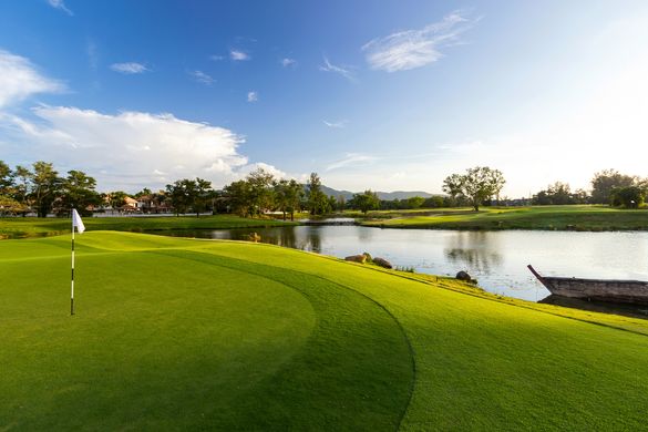 Unique features include wood ties on some steep fairway edges and traditional Thai fishing boats placed in watercourses to enhan
