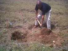 Ben Malasi planting a tree for a reforestation project in Kenya