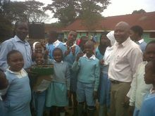 Ben  Malasi with local school handing over donations from a client
