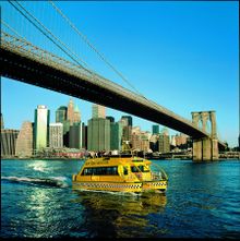 New York Water Taxi Riders Enjoy the Majesty of the Brooklyn Bridge.