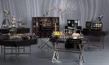 Chic Sensation themed break boasts stylish glassware and creative cabinets bursting with global flavors and desserts hanging fro