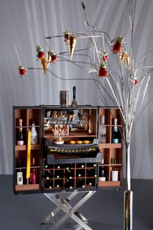 Chic Sensation themed break boasts stylish glassware and creative cabinets bursting with global flavors and desserts hanging fro