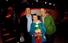 Tour guide Pat Curran (left) presents Wilma and Daniel with a lucky mascot and a model CIE Tours’ coach; a gift for their 18th v