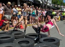 Female impersonators endeavor to navigate a course on Duval Street Saturday, April 19, 2014, during the Great Conch Republic Dra
