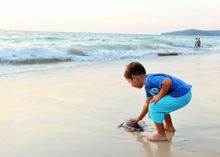 a kid seeing his new friend off from Bangtao Beach, Phuket, to an ocean odyssey 