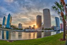 Dawn breaks over downtown as a lone rower plies the Hillsborough River at sunrise