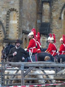 Sherborne Abbey and Almshouses provide a backdrop for troops in Far from the Madding Crowd